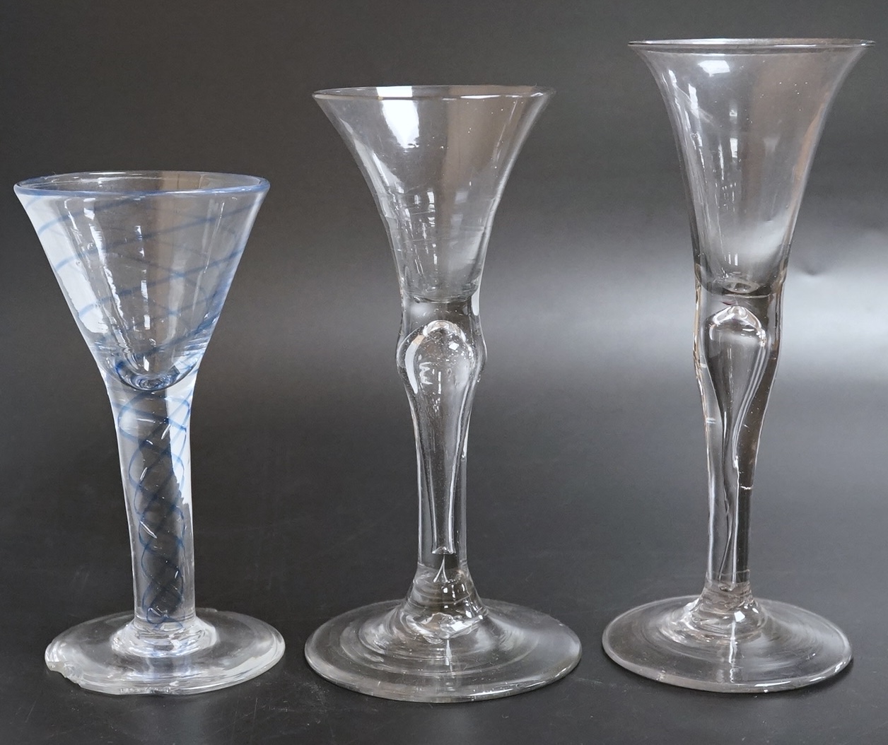 Two drawn wine glasses, each with air-tear stems, and a drawn-stem wine glass with blue internal twist, tallest 17cm high (3)